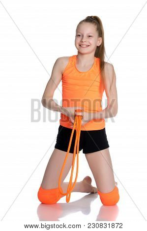 A Girl Gymnast Performs Exercises With A Skipping Rope. The Concept Of A Healthy Lifestyle, Sports E