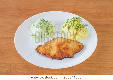Pork Chop With Sliced Cucumbers With Sour Cream And Mashed Potatoes.