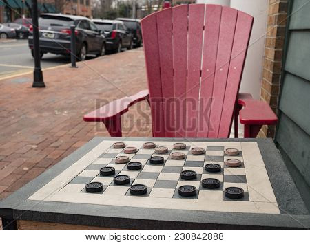 Checkers Game In Public On Sidewalk, Step Up And Take A Seat To Play The Game With A Friend Or Stran