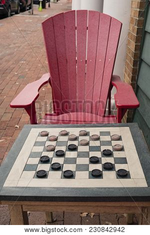 Checkers Game In Public On Sidewalk, Step Up And Take A Seat To Play The Game With A Friend Or Stran