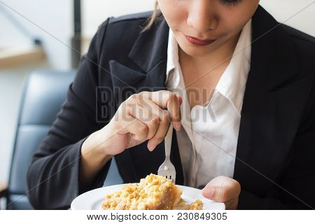 Asian Business Woman In Relax Time And Eating Apple Pie In Coffee Shop. Hand Holding  Spoon Used To 