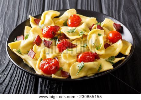 Italian Dumplings Casoncelli With Ham Prosciutto, Cherry Tomatoes And Greens Close-up. Horizontal