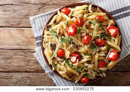 Penne Pasta With Fried Mushrooms, Tomatoes, Pepper And Cheese Close-up. Horizontal Top View
