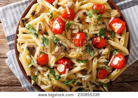 Italian Penne Pasta With Fried Mushrooms, Tomatoes, Pepper And Parmesan Close-up. Horizontal Top Vie