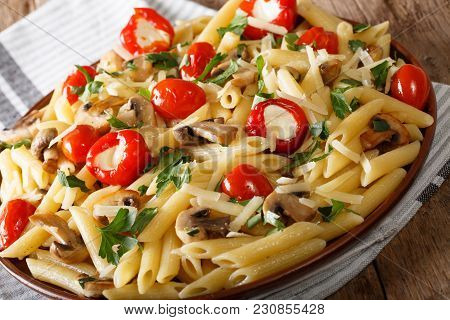 Italian Food: Penne Pasta With Mushrooms, Cherry Tomatoes, Stuffed Peppers Close-up. Horizontal