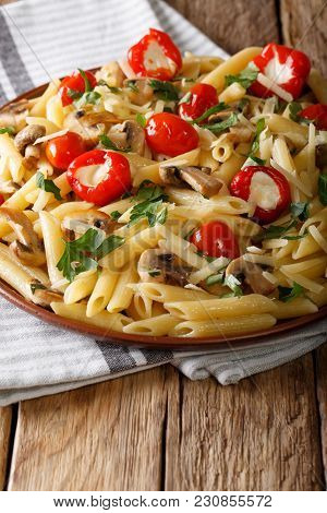 Italian Penne Pasta With Fried Mushrooms, Tomatoes, Pepper And Parmesan Close-up. Vertica