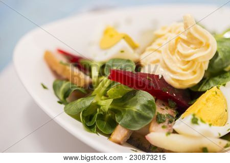Potato Salad With Red Beet, Smoked Herring, Egg And Soy-bean Mayonnaise. Close-up Photo