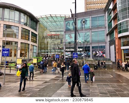 MANCHESTER, ENGLAND - MARCH 10, 2018: Pedestrians wall outside The Arndale a Shopping Centre entrance on Exchange Square in Manchester, Northern England, UK.