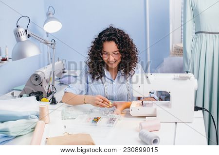 Smiling Dressmaker Sitting On The Chair And Collecting Beads. Handmade And Handicraft