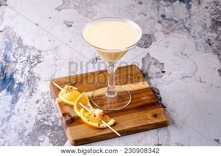 Alcoholic Cocktail - Midori With Rum, Colada, Pineapple And Cream With Ice, Orange Slice In A Martin