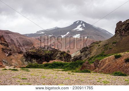 Icelandic Landscape With Red Hills In Lonsoraefi In Cloudy Weather