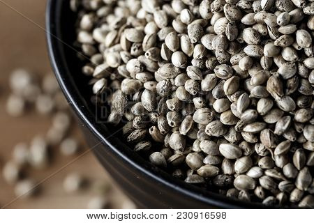Cannabis Seeds In A Plate, On A Wooden Background, Space For Text