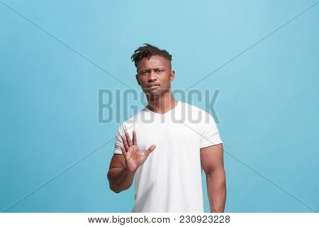 Young Man With Disgusted Expression Repulsing Something, Isolated On The Blue