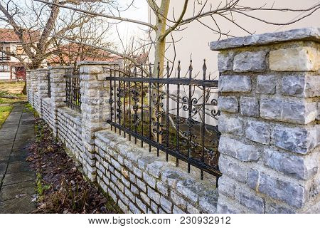 Black Wrought Iron And Cut Stone Fence, Fence On Wall