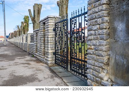Wrought Iron And Cut Stone Fence With Gate
