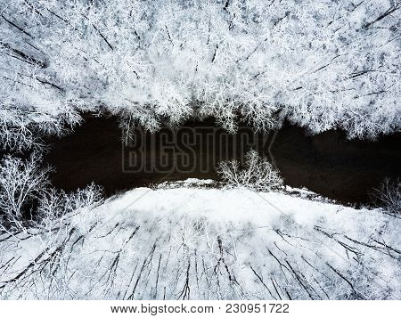Aerial View Of Snowy Forest And Stream