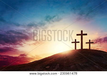 Silhouette Cross On Calvary Mountain Sunset Background. Easter Concept