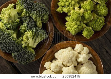 Top View Of Fresh Pieces Of Romanesco Broccoli, Broccoli And Cauliflower In Small Rustic Wooden Bowl