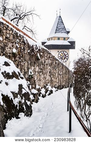 Path To Snow Covered Uhrturm Clocktower Landmark Of City Graz On Hill Schlossberg In Winter