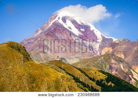 Scenic Landscape View Of Kazbeg Mountain And Tsminda Sameba Church, Country Of Georgia