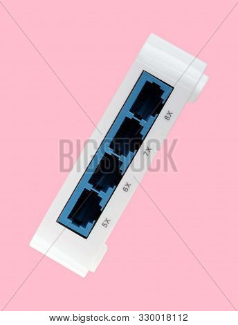 White 8 Port Plastic Ethernet Switch Isolated On Pink Background At Dry Day