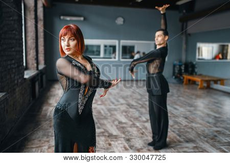 Man and woman on ballrom dance training in class
