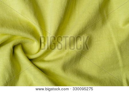 Close-up Fragment Of Crumpled Beautiful Yellow Cotton Fabric. Concept Of High-quality Raw Materials 