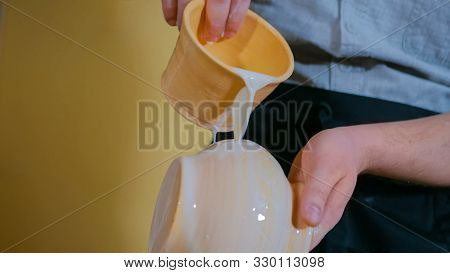 Professional Male Potter Preparing Ceramic Wares For Burning In Pottery Kiln With Milk - Old Russian
