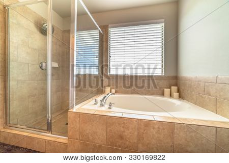 Built In Circlar Bathtub Deside A Shower Stall Inside The Bathroom Of A Home