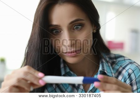 Surprised Woman Hold Pregnancy Tes In Hand Portrait.