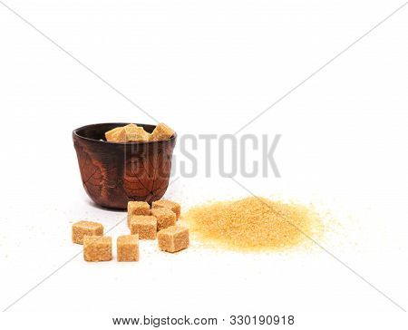 Sugar In A Ceramic Bowl On A White Table. Brown Crystalline Sugar. Junk Food. Isolated Background.