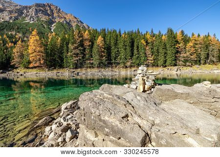 Autumn Time At Romantic Mountain Lake With Stone Cairns In Foreground. Lake Obernberg, Stubai Alps, 