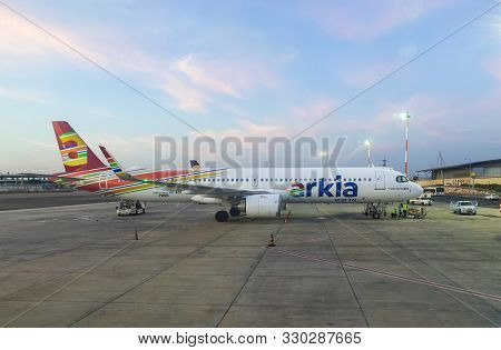 Tel Aviv, Israel, October 08, 2019 : Arkia Airlines Plane Stands At Sunrise Near The Terminal While 