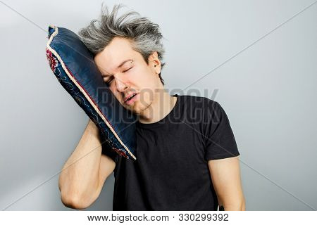 Portrait Of A Sleepy Long Haired Guy With A Blue Pillow Who Has Insomnia And Who Dreams Of A Good He