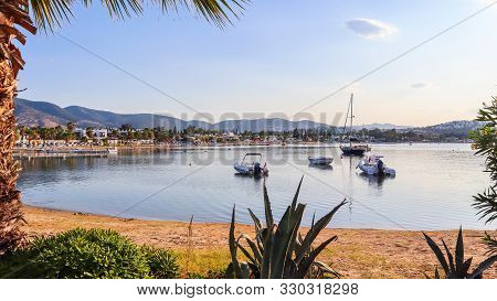 Beautiful Bay With Calm Water, Sandy Beach, Boats And Yachts. Small Town And Green Mountains On The 