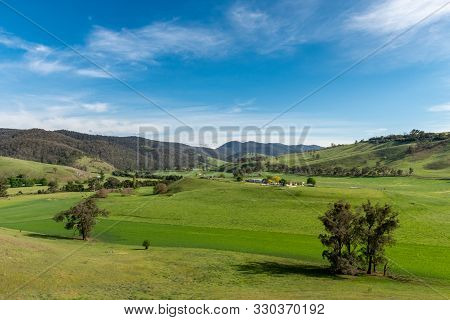 Rolling Green Fields Of Central Tilba On A Partially Cloudy Day In Tilba Tilba, Nsw, Australia.