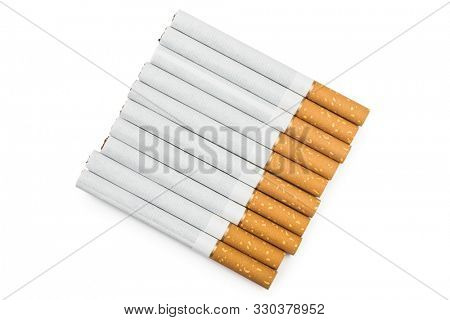 Ten tobacco cigarettes in a row isolated on white background with clipping path. Top view. When smoking ten cigarettes or less per day, the risk of disease is greatly reduced. Design element