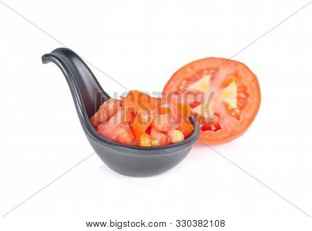 Cut Cube Tomato In Black Spoon And Haf Cut Tomato On White Background