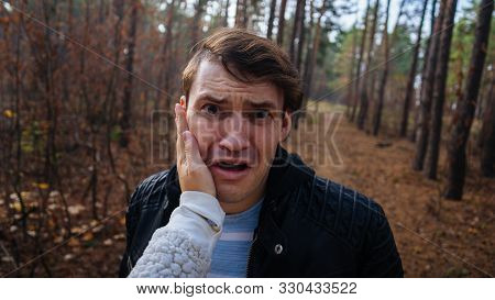 A Womans Hand Hits A Mans Face In The Autumn Forest. An Emotional Male Is Getting Slapped In Face, W