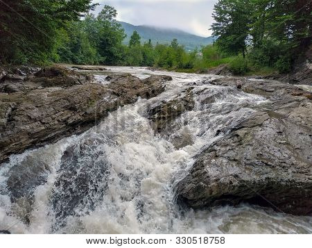 A Fast Mountain River Running Along The Picturesque Banks Of The Carpathians.