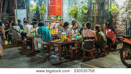 People Eating Street Food In Old Quarter Of Hanoi By Night