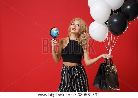 Smiling Young Woman Girl In Black Clothes Posing Isolated On Red Background In Studio. Shopping Disc