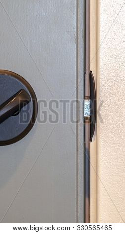 Vertical Frame Close Up Of Locked Deadbolt Latch On Home Door