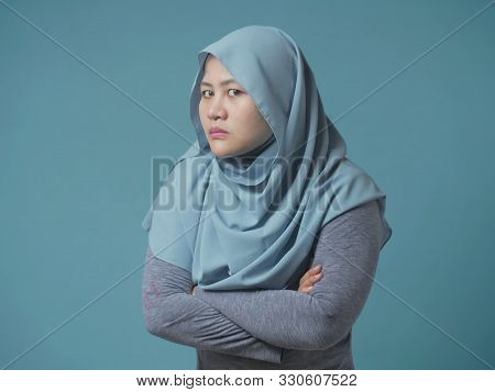 Portrait Of Angry Cynical Asian Muslim Woman With Suspicious Expression Looking At Camera, Mistrust 