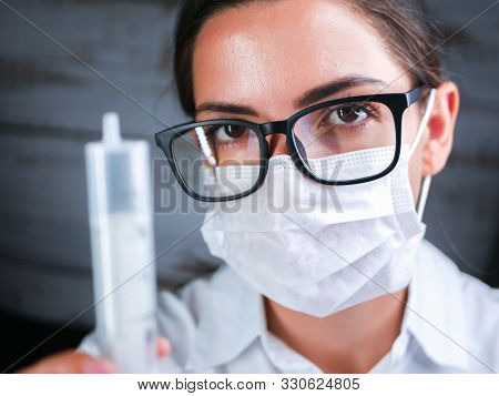 The Girl Works In The Dna Laboratory. A Young Female Technician Or Scientist Works In A Laboratory. 