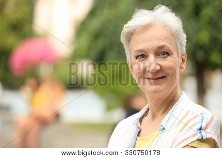Portrait Of Happy Mature Woman Outdoors, Space For Text. Smart Aging