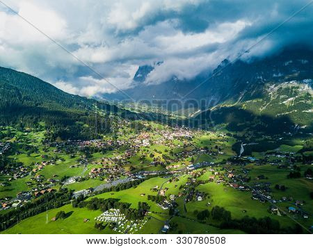 Sun Shines Over Swiss Village Grindelwald After Heavy Storm In Summer Time Near Swiss Alps