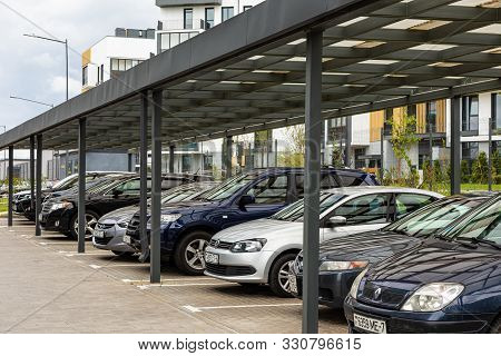 Minsk, Belarus - May 2019. Parking Space With Row Of Cars Under Shed In Percinct Of Dwelling House