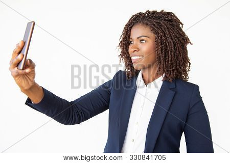 Cheerful Smiling Manager Taking Selfie On Smartphone. Young African American Business Woman Standing