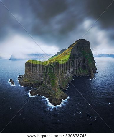 Aerial Panorama Of A Small White Lighthouse Located On The Edge Of A Huge Cliff And The Island Of Ka